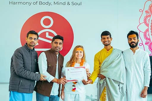 Daniele Ramos de Souza, student of Nirvana Yoga School India receiving her 500 hour YTTC certificate	